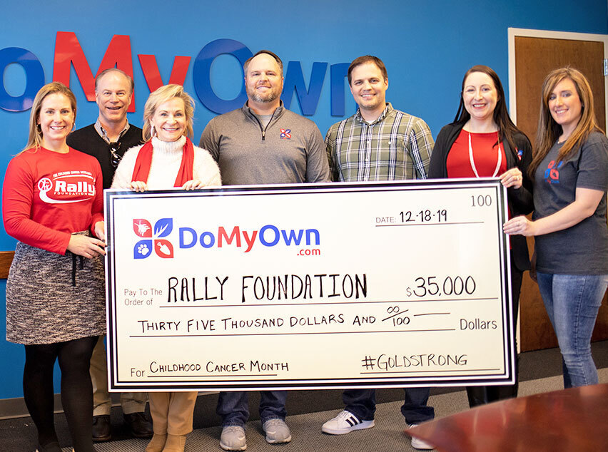 DoMyOwn team presenting a donation check to the Rally Foundation
